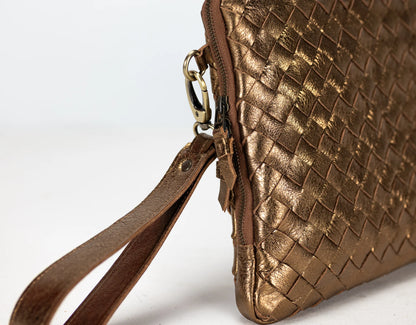 Gold woven handbag with a strap on a white background
