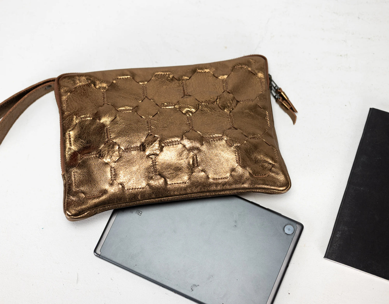Bronze textured pouch on a white background