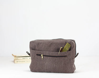 Brown fabric pouch with a zipper on a white background