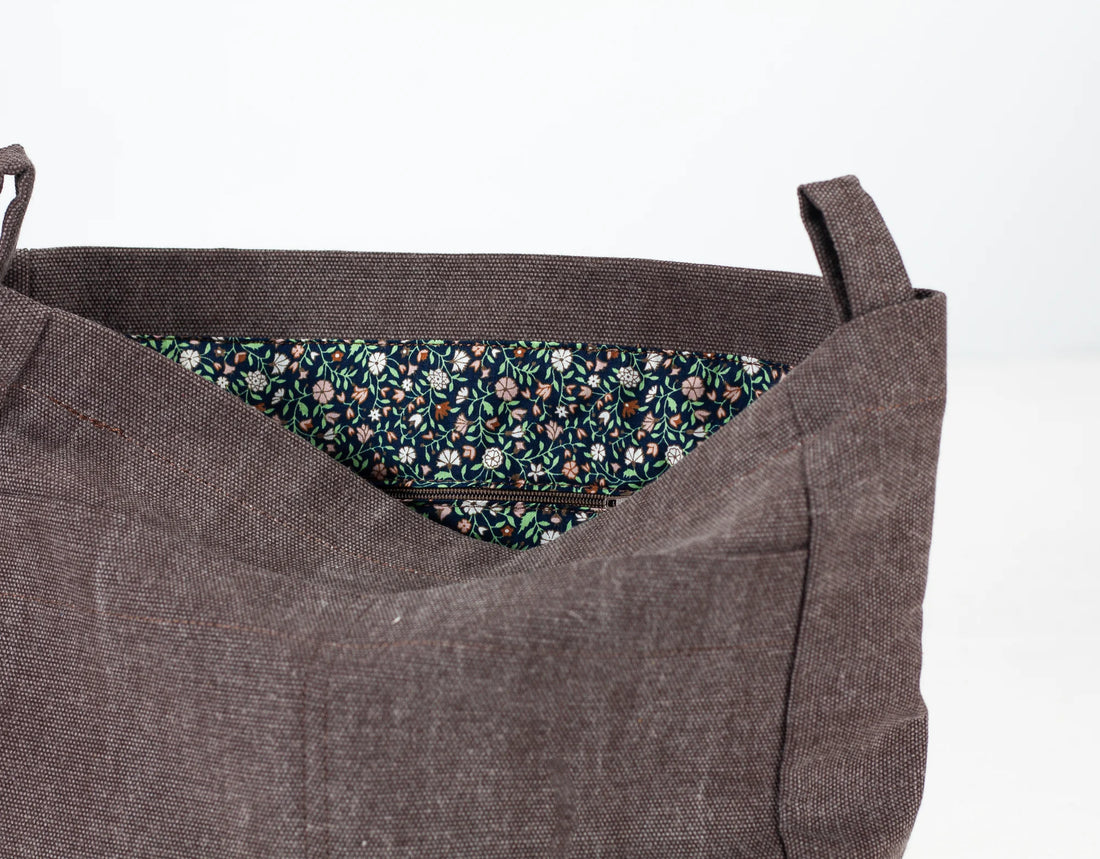 Brown fabric bag with floral lining on a white background