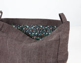 Brown fabric bag with floral lining on a white background