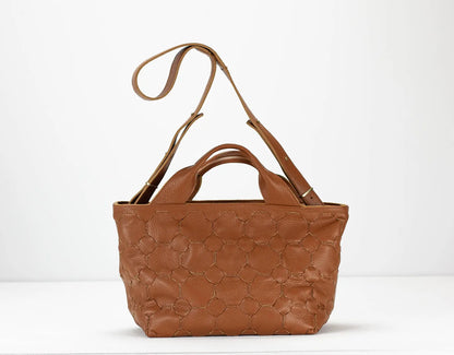 Brown leather handbag with quilted pattern on a white background