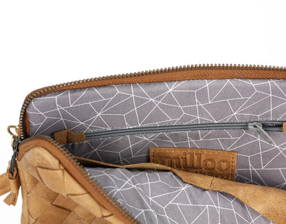 Close-up of a brown leather pouch with geometric patterned interior, featuring the brand milloo.