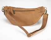 Brown leather bag with a strap on a white background