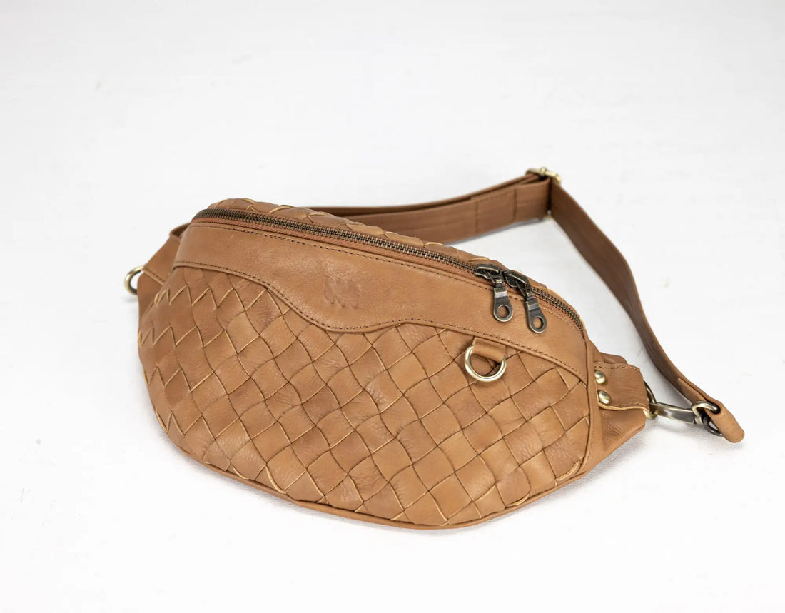 Brown woven leather waist bag on a white background