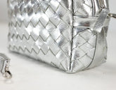 Silver woven handbag on a light background