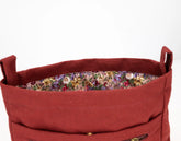 Red fabric basket with floral lining on a white background