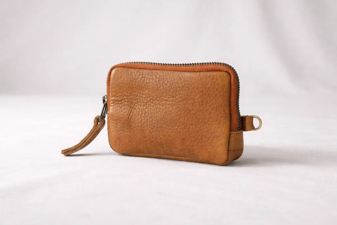 Brown leather wallet with a zipper tassel