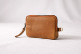 Brown leather wallet with a zipper tassel