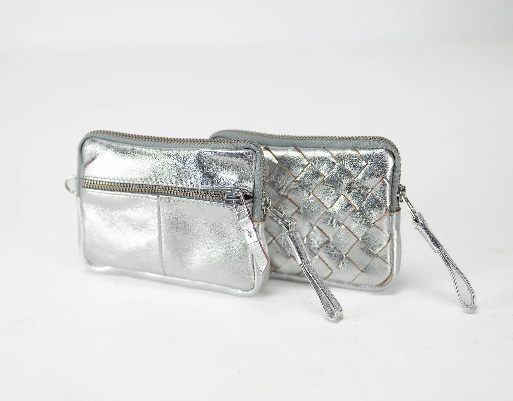 Silver quilted wallet with a strap on a white background