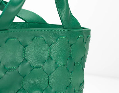 Green woven handbag on a white background
