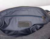 Gray bag interior with a visible &