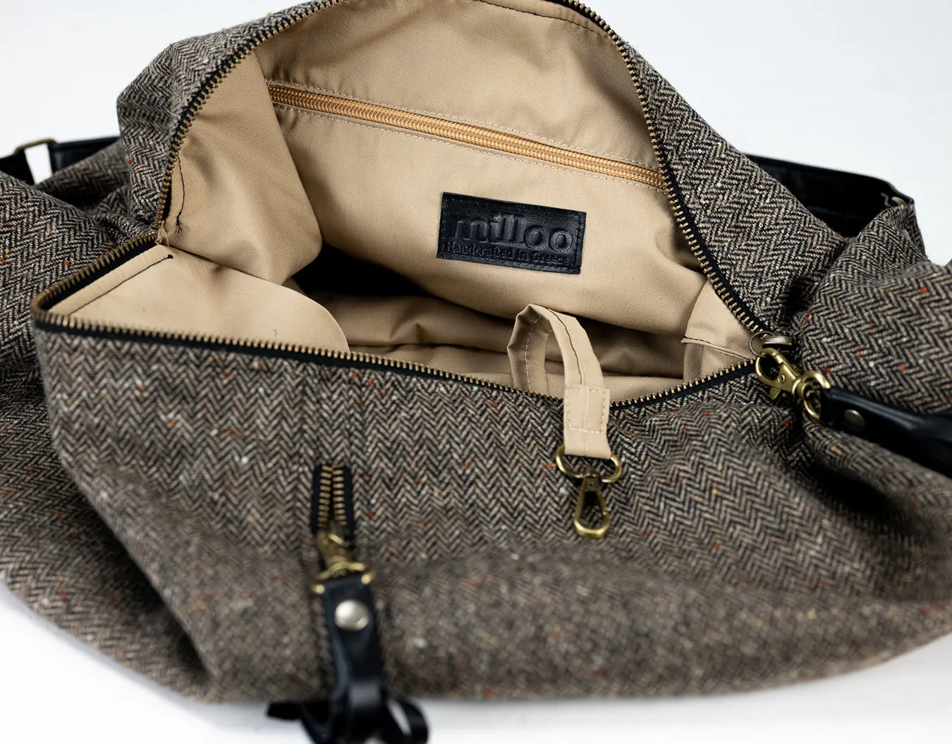 Brown textured bag with beige interior and visible brand logo on a white background