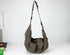 Gray shoulder bag with a strap on a white background