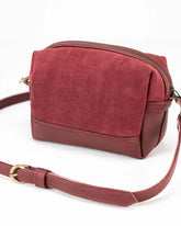 Red crossbody bag on a white background
