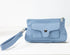 Light blue handbag with a strap on a white background