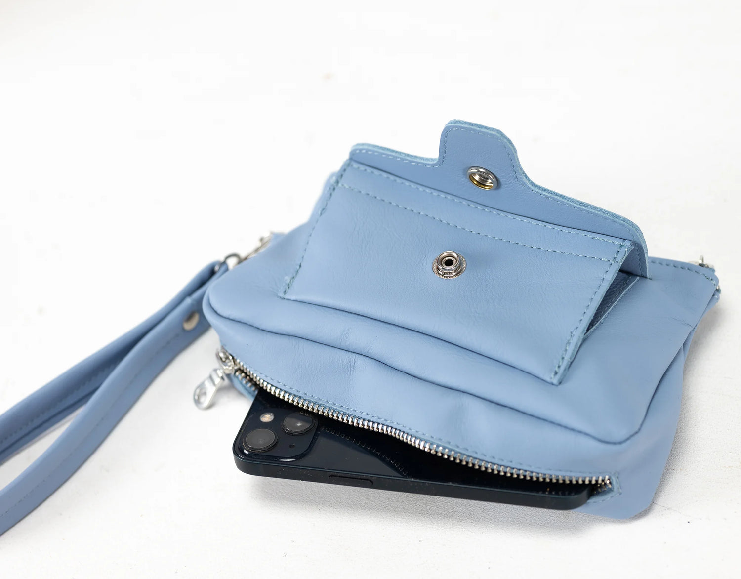 Light blue handbag with a strap on a white background
