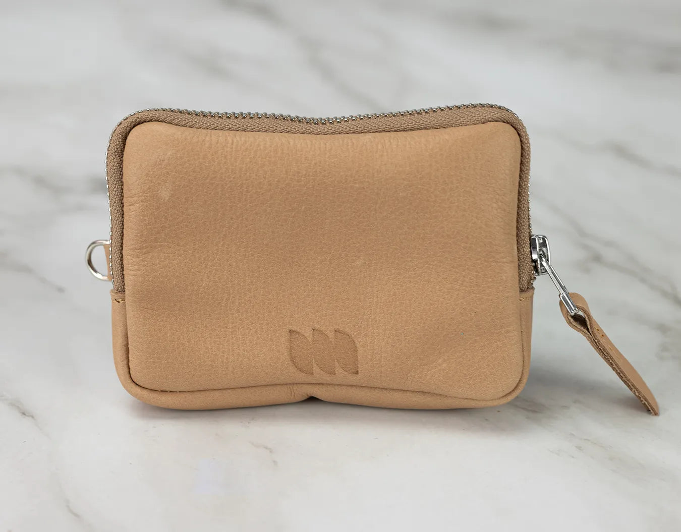 Tan zippered pouch on a light gray background
