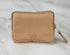 Tan zippered pouch on a light gray background