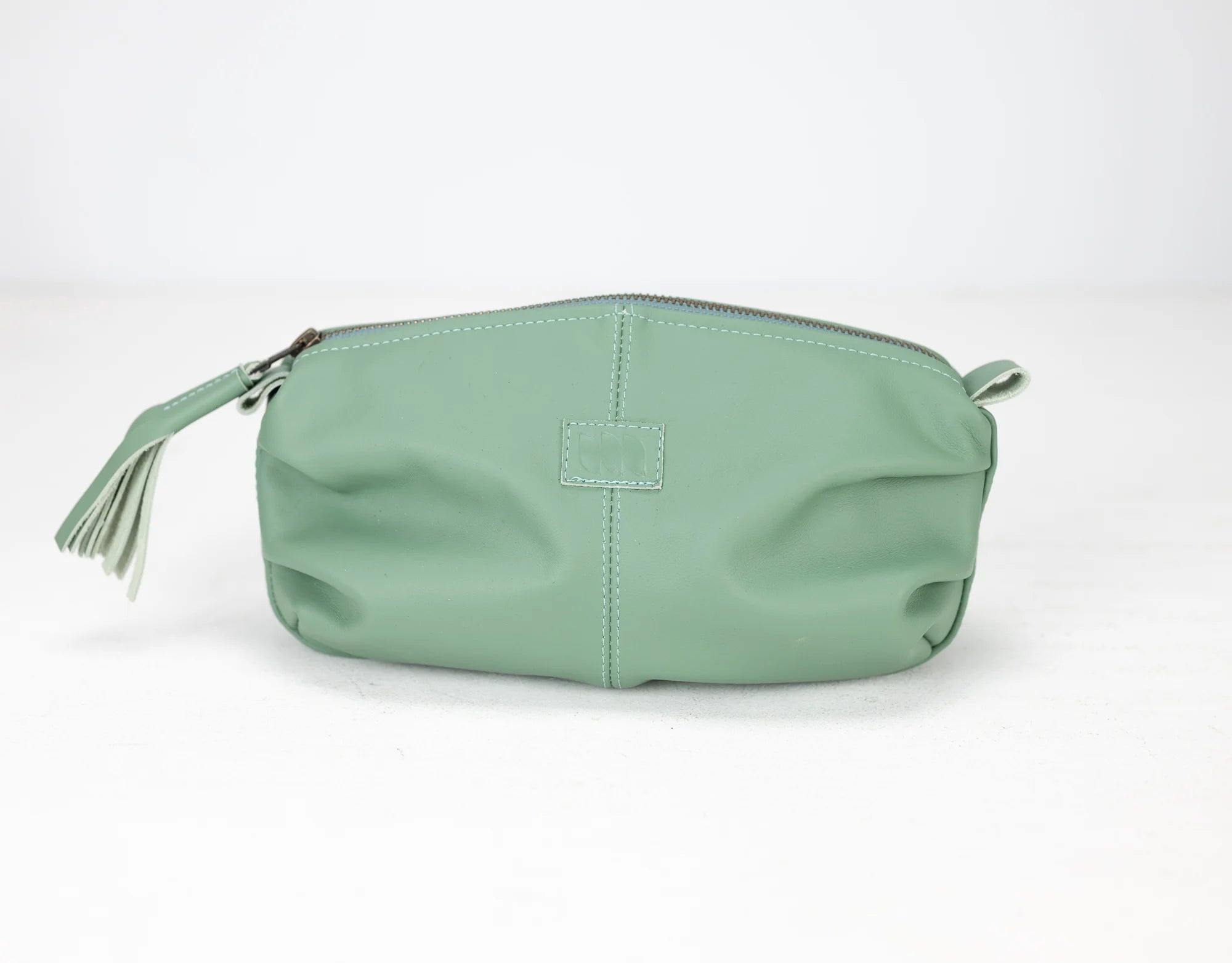 Mint green pouch with a zipper on a white background