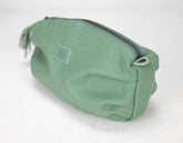Green toiletry bag with a zipper on a white background