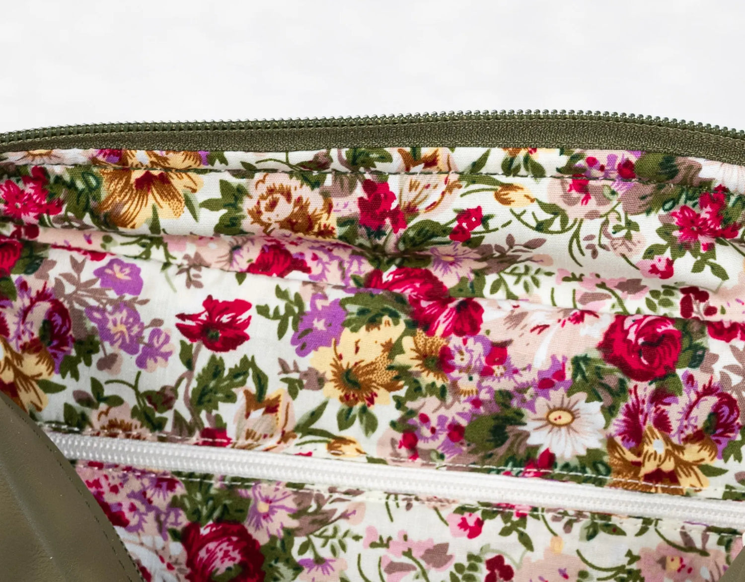 Floral-patterned fabric with a zipper on a white background