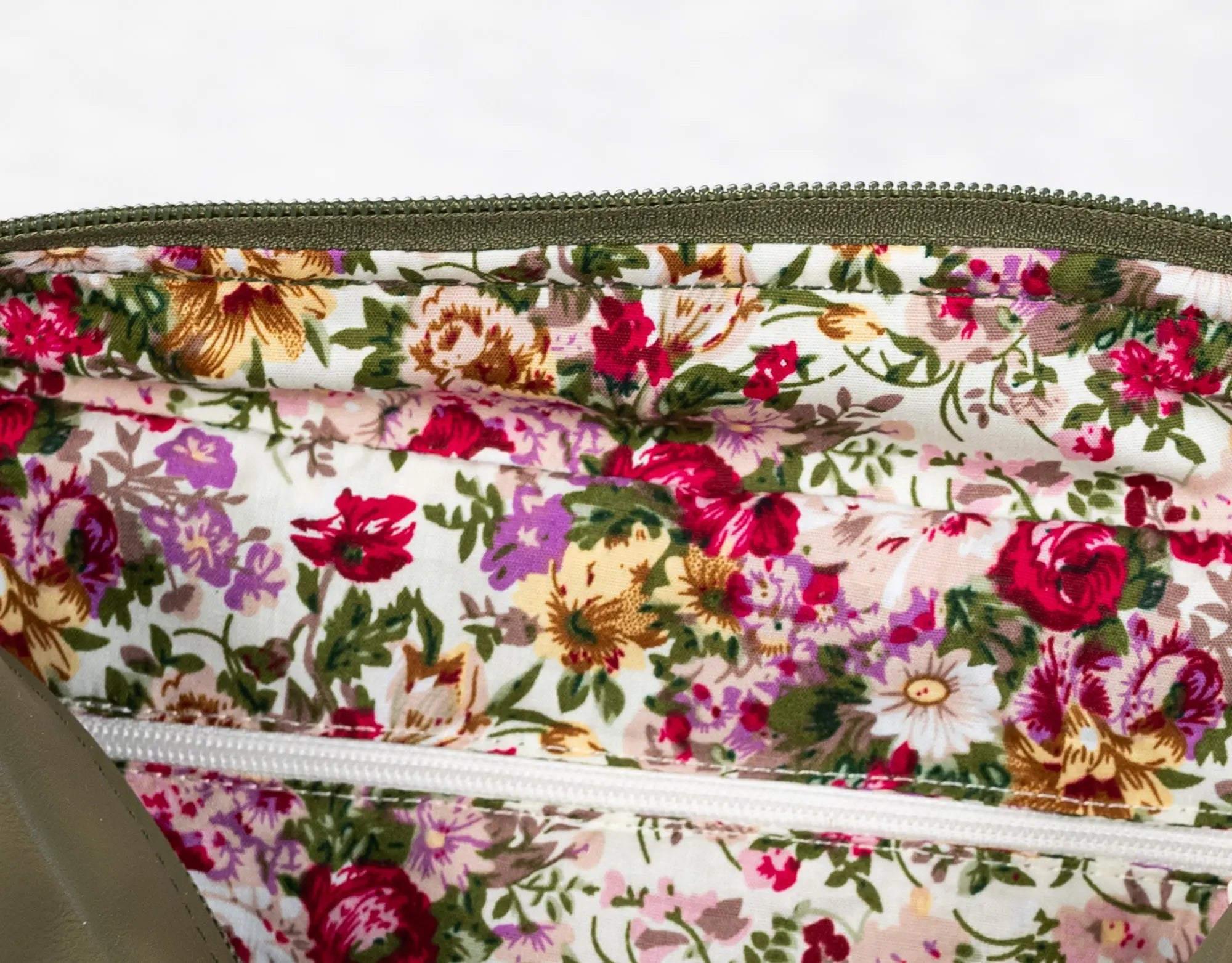 Floral-patterned fabric with a zipper on a white background