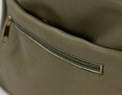 Close-up of a green leather bag with a zipper.