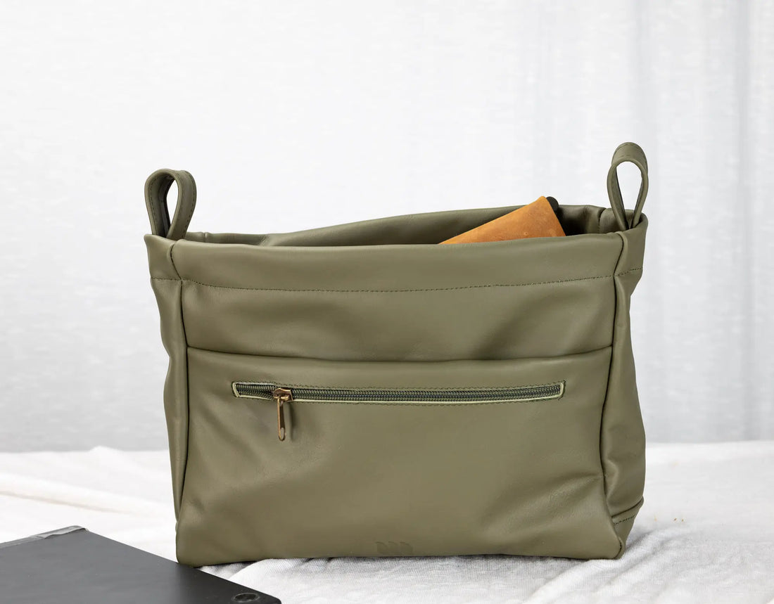Green bag with a zipper on a white background