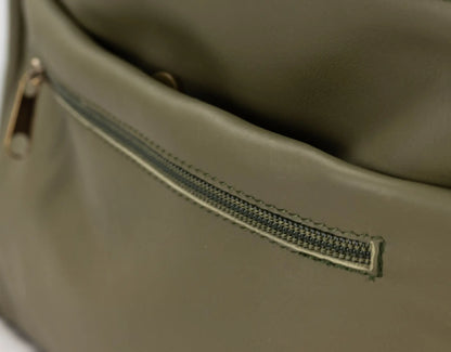 Close-up of a green leather bag with a zipper