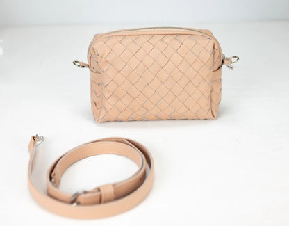 Beige woven handbag with matching strap on a white background