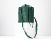Green textured handbag with a strap on a white background