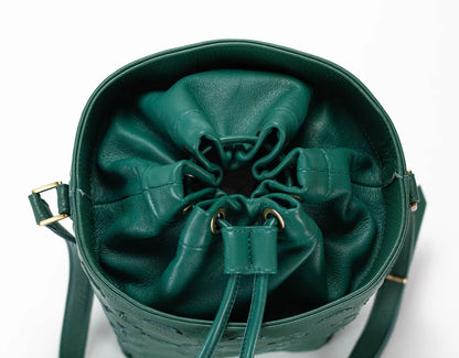 Green leather drawstring bag on a white background