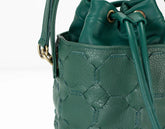 Green textured handbag with drawstring on a white background