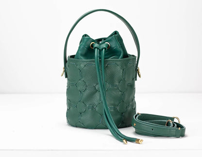 Green quilted handbag with a strap on a white background