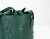 Green textured handbag on a white background