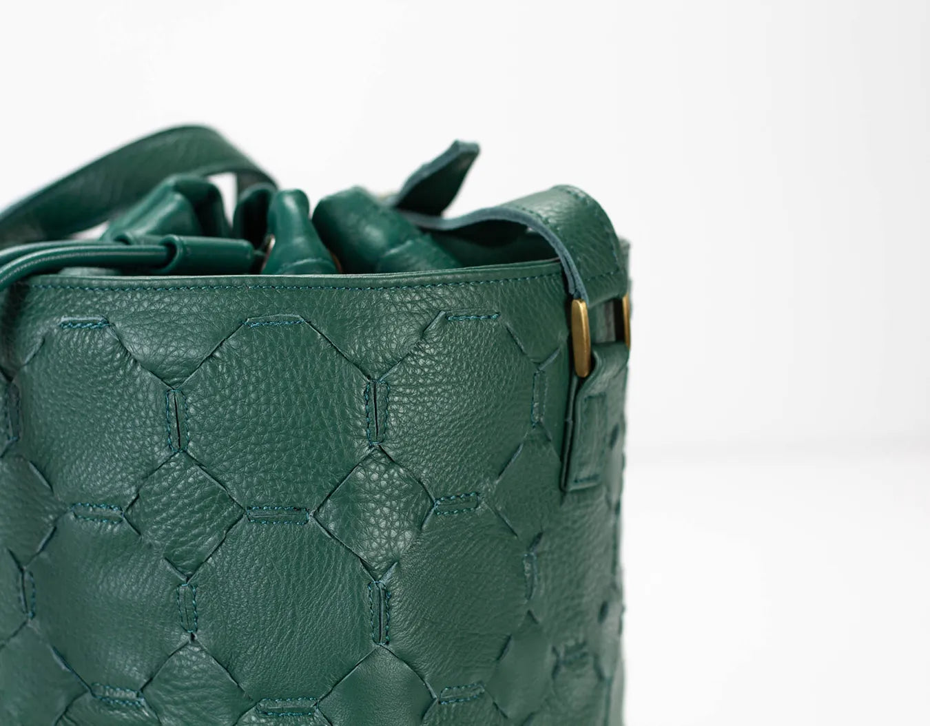 Green textured handbag on a white background