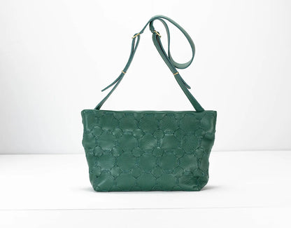 Green textured handbag with a strap on a white background