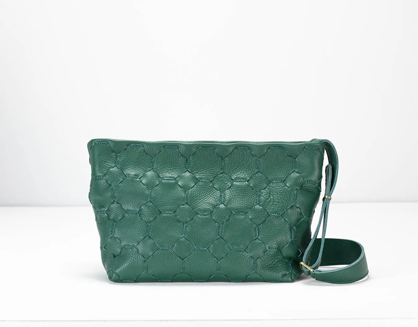 Green textured handbag with a strap on a white background