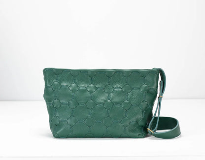 Green textured handbag with a strap on a white background