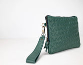 Green woven clutch bag with wrist strap on a white background