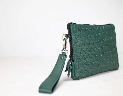 Green woven clutch bag with wrist strap on a white background