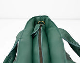 Green leather bag with a zipper on a white background