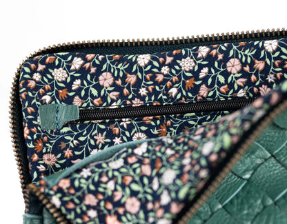 Floral patterned clutch bag with green accents