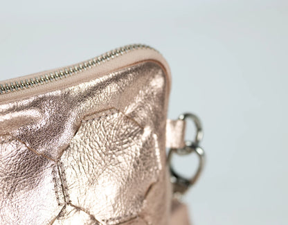 Rose gold metallic wallet on a light gray background