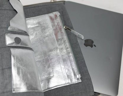 Gray laptop case with a silver laptop inside, showing Apple logo.
