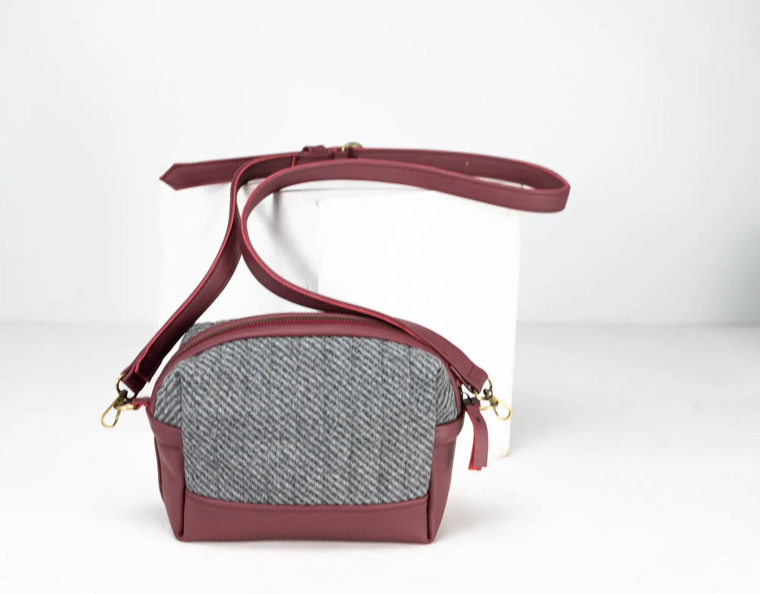 Maroon crossbody bag with a gray textured section