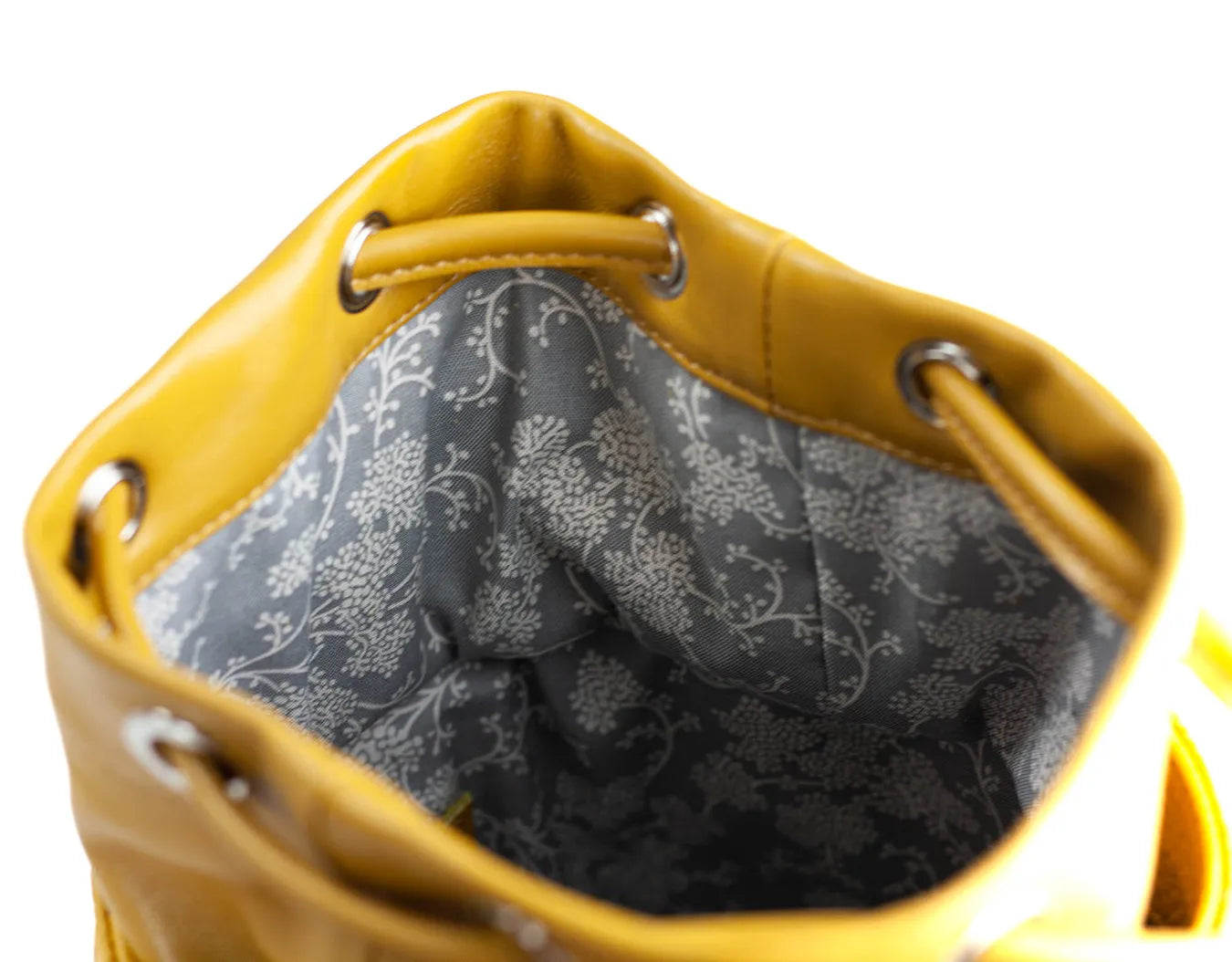 Yellow handbag with floral patterned interior on a white backgroundy