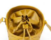 Yellow leather drawstring bag on a white background