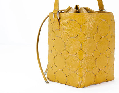 Yellow textured handbag on a white background
